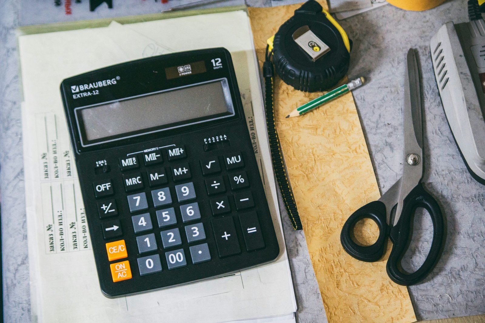 Calculator and stationery used to plan a renovation budget