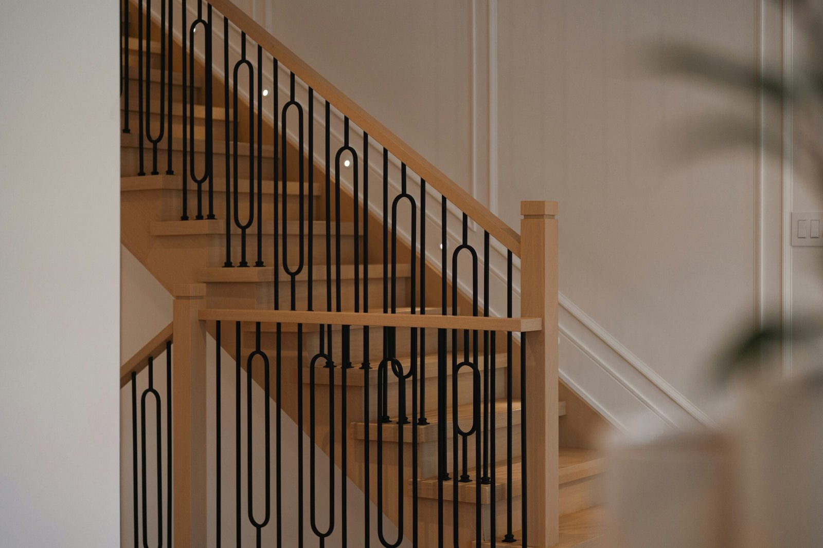 Modern timber staircase with dark metal balustrade